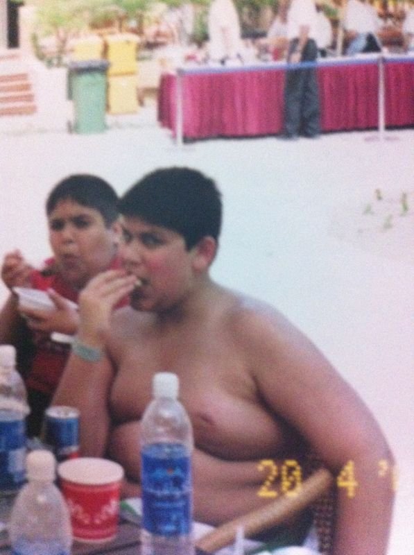 Sid as a boy, eating at a table on holiday